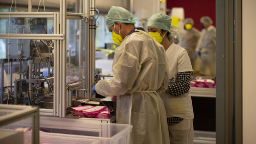 Workers produce TImask surgical masks